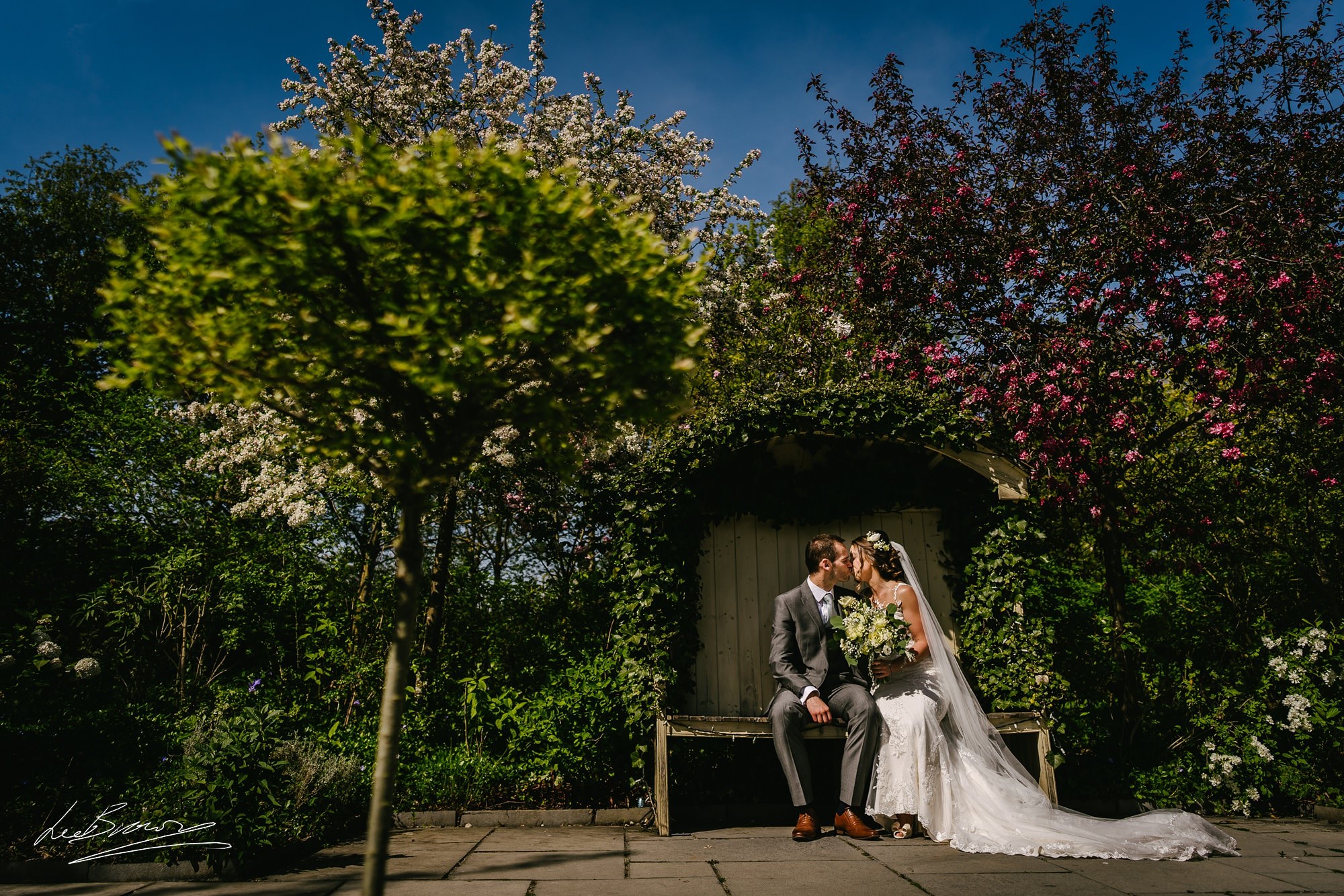 the couple sat in the gardens at Styal Lodge after their wedding